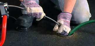 a plumber in Germantown is unclogging a drain